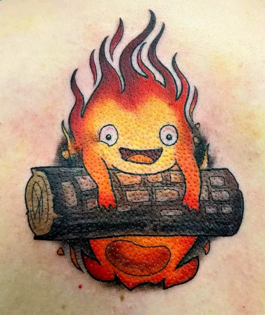 Tattoo of a smiling cartoon fire figure sitting on a log.